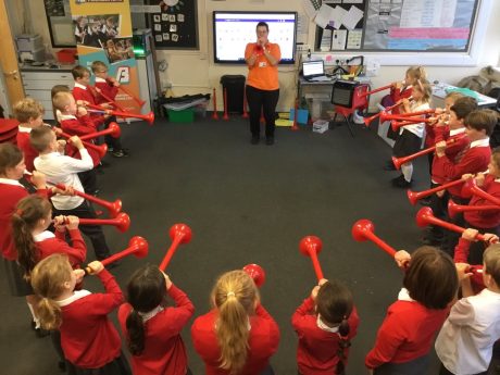 Helen stood at the front of the room, surrounded by a semicircle of children playing pBone instruments