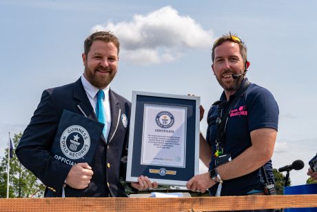 A Guinness World Records officiant giving the Guinnes World Records Certificate to a member of staff from Norfolk Music Hub.