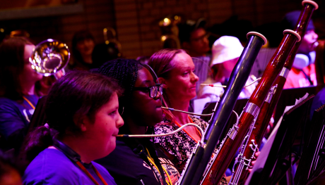 Three young people playing the bassoon